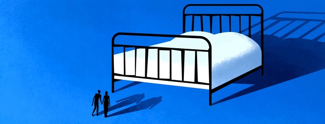 A man and woman holding hands look up at large bed