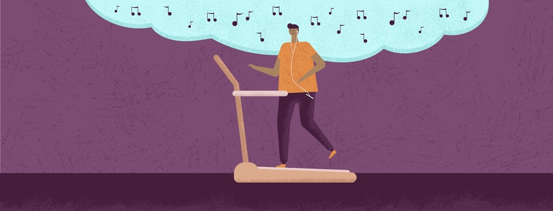 man listening to music while walking on a treadmill