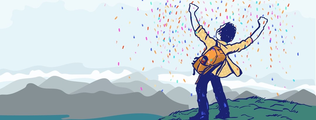 a man stands at the top of a mountain and is showered with confetti