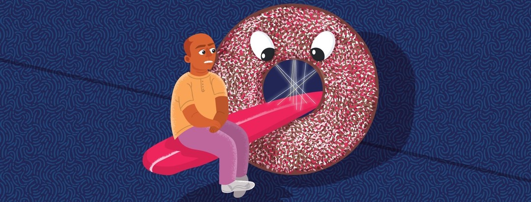 A man sits on the outstretched tongue of a giant donut with eyes and lasers in its mouth