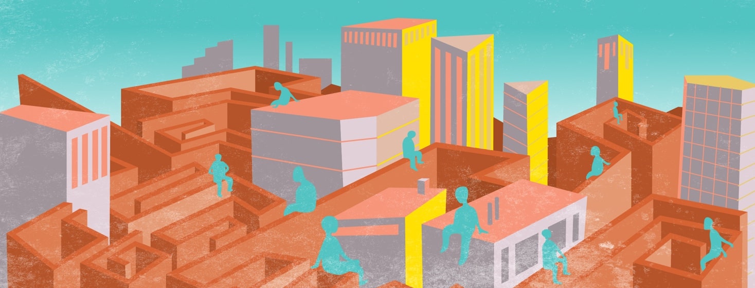 Men sit on the walls of a maze surrounding large buildings