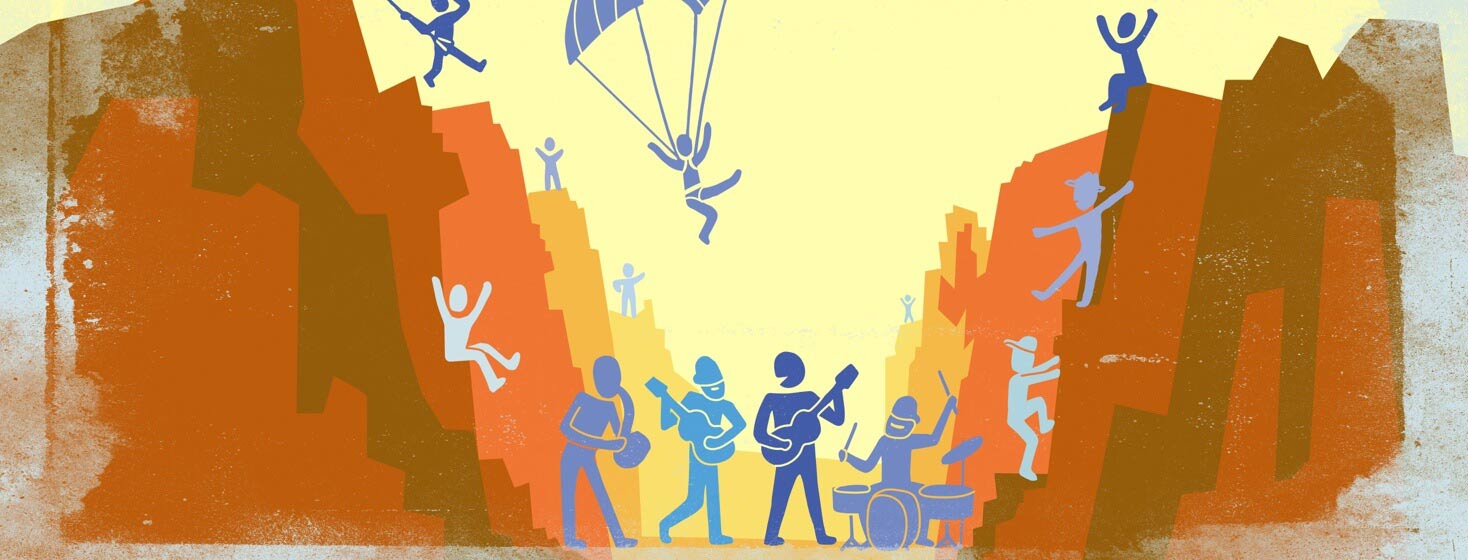 a band playing at the bottom of a canyon with people all around cheering