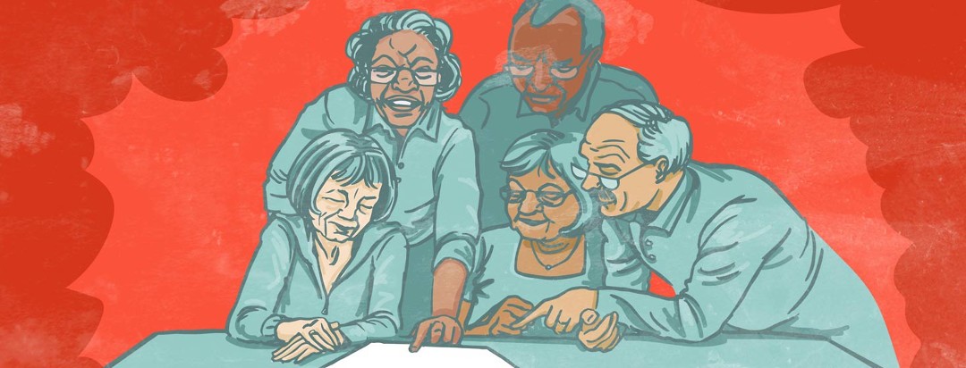 a group of seniors look at a paper on a table. One woman looks up with a smile.