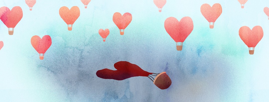A multitude of heart-shaped hot air balloons float in the background, while a central lone balloon is completely deflated on the ground.