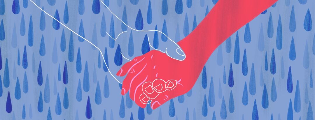 A hand holding the outline of a missing hand in the middle of a rain shower