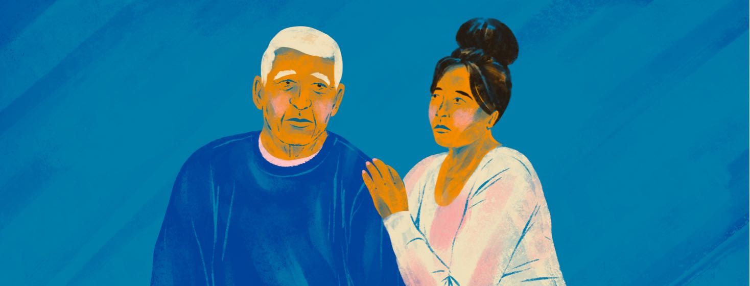 A younger woman has her hand on the shoulder of an older man.