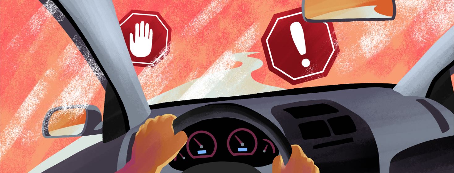 From the point of view of the driver's seat, a car driving on a path is blocked by warning signs.