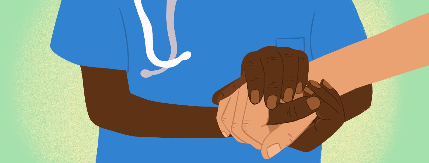 A nurse or doctor holds the hand of a patient.