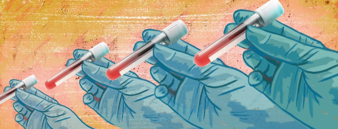 Blue gloved hands hold vials of blood samples.