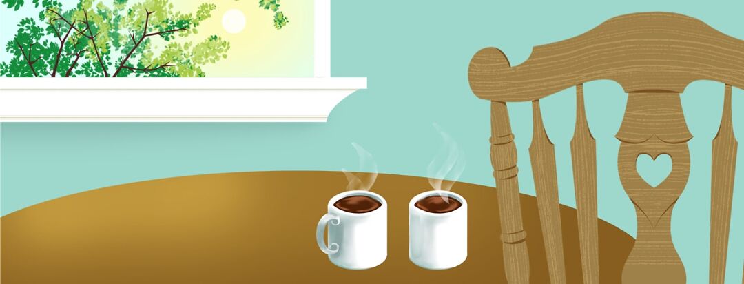 A wooden chair with a heart cutout sits at a table next to a window that shows a sunset. There are two coffee mugs with steam rising from the top.