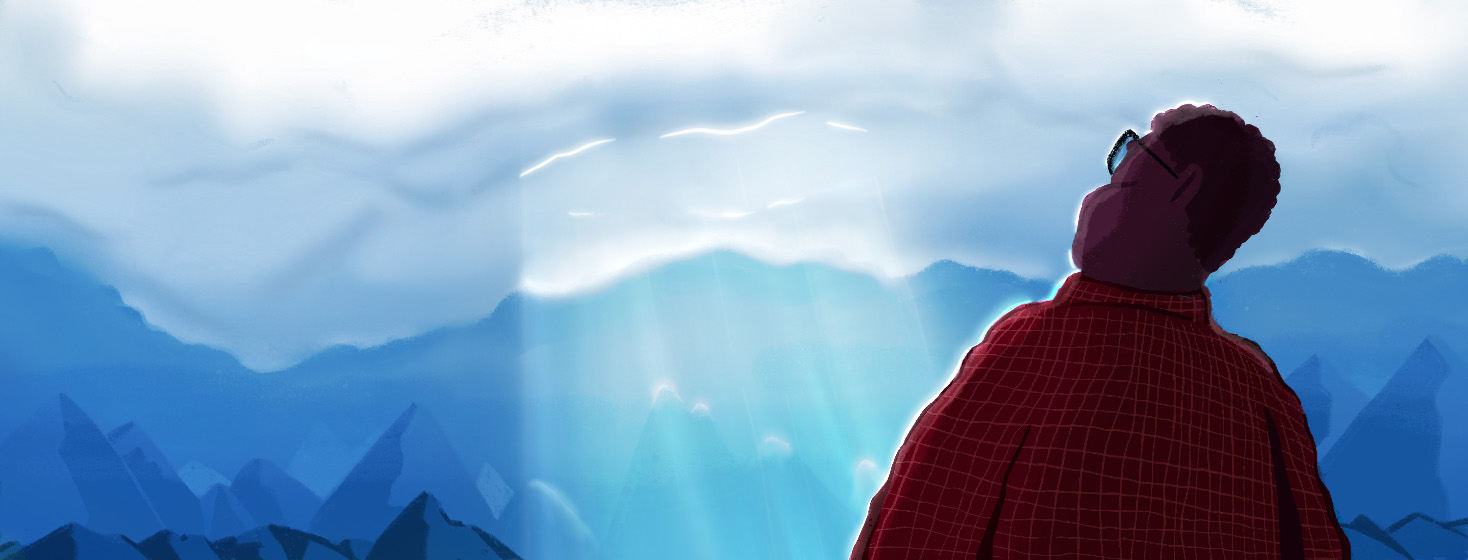 A senior gentlemen cast in heavy shadow looking up at the clouds against tall mountains with a ray of sun poking through.